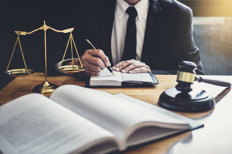 male lawyer or judge working with contract papers 5ZV28KL